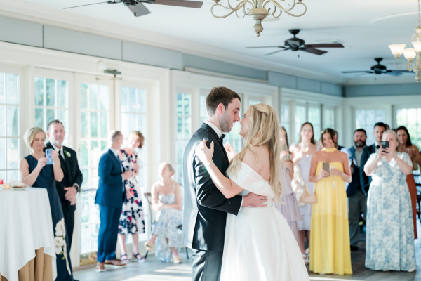 Bride and Groom having their first dance in front of their wedding guests
