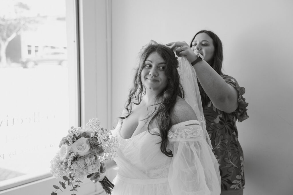 south carolina wedding planner assisting bride with putting on veil