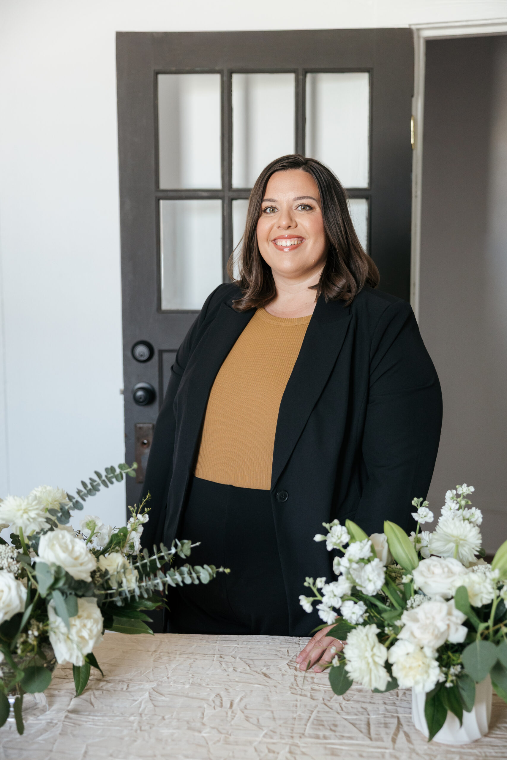 Wedding planner posing with bridal bouqets